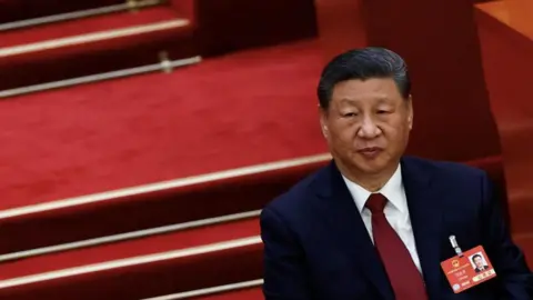 Reuters Chinese President Xi Jinping in a suit attends the opening session of the National People's Congress (NPC) at the Great Hall of the People in Beijing, China, March 5, 2025