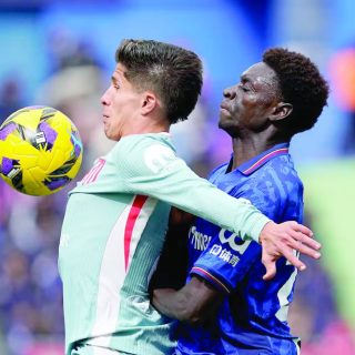 atletico madrid s giuliano simeone in action with getafe s coba da costa during the laliga fixture at estadio coliseum getafe on march 9 photo reuters