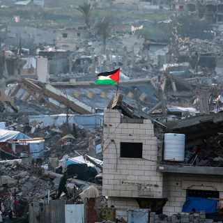 a palestinian flag flutters amid the ruins of buildings in beit lahia in northern gaza on march 4 2025 photo afp