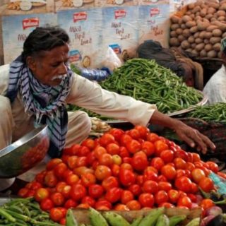 man sells vegetables at the empress market in karachi pakistan photo reuters