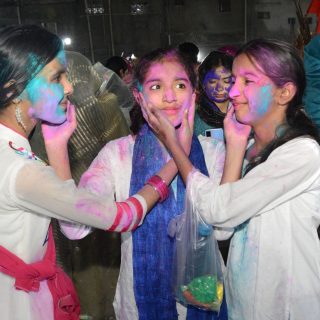 festival of colours young girls smear colour on each other as part of holi celebrations at the swaminarayan mandir in karachi photo express