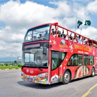 students and government officials enjoying a ride on the double decker bus wave during the test run of the service on friday photo express