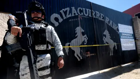 Getty Images National Guard officers stand guard while members of the collective "Warriors seekers" visit the Izaguirre ranch, where on March 5 they located three human crematory ovens 