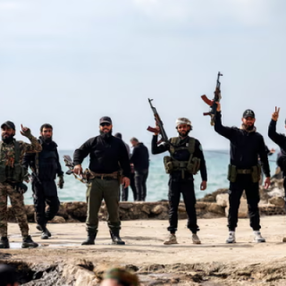 members of security forces loyal to the interim syrian government pose by the mediterranean coast in syria s western city of latakia photograph photo afp