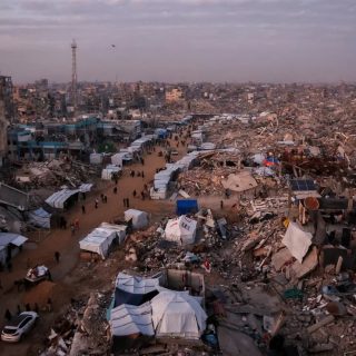 palestinians walk through rubble in gaza photo afp