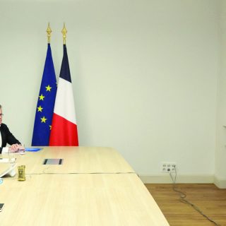 french president emmanuel macron attends a videocall as he takes part in a virtual summit held by britain s prime minister keir starmer on screen at the elysee palace in paris photo afp