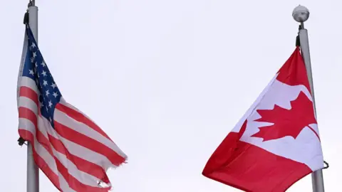 Getty Images File image of the American and Canadian flags flying side by side